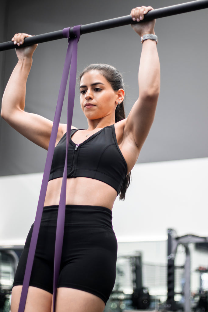 girl doing assisted pull-ups with resistance band