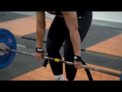woman using lifting straps for Romanian deadlifts